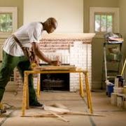a man working on a wood plank