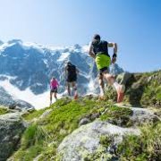 a group of people running up a mountain